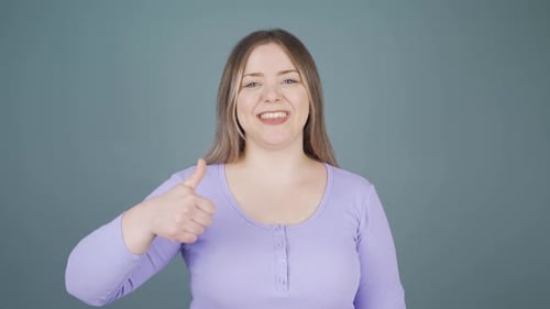 Smiling Woman Giving Thumbs Up and OK Signs