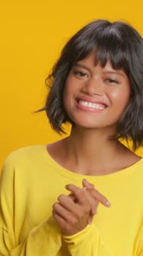 Woman Laughing with Hands Together in Studio