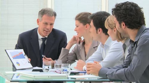 Happy Business Team Discussing Charts