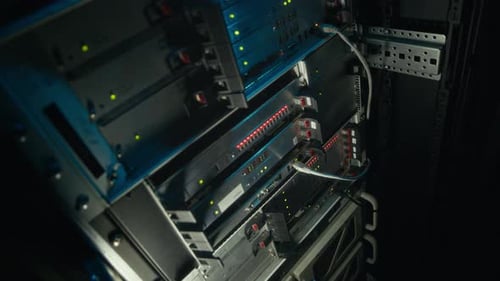 Servers with Blinking Lights in a Dark Room