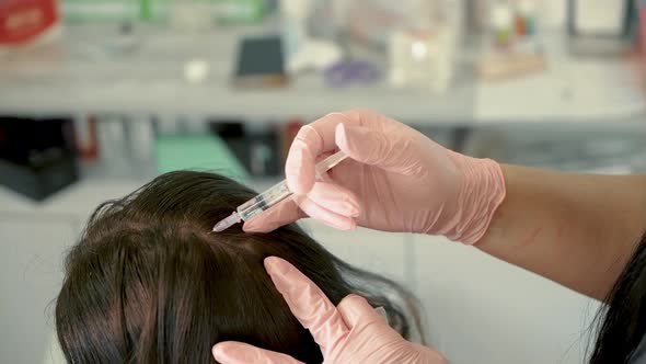 Woman receiving scalp injection in clinic, Medical Stock Footage ft ...