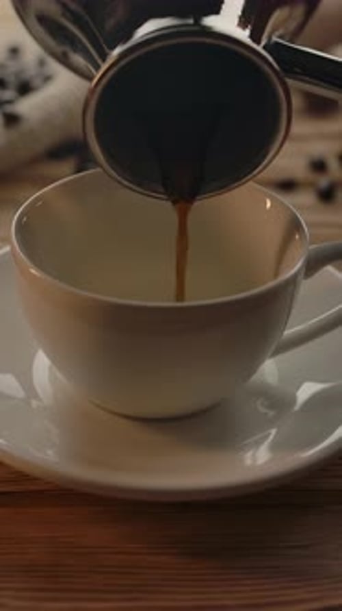 Vertical of Unrecognisable Person Pouring Coffee From Cezve on White Cup