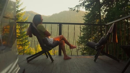 Young Woman Alone Enjoys Freshness of Summer Nature on Terrace