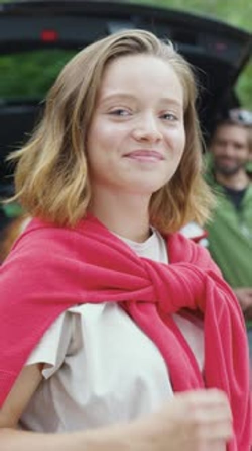 Smiling Young Woman With Red Sweater In Nature