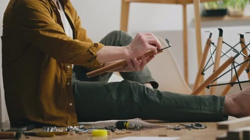 Adult Assembling Furniture on the Floor at Home