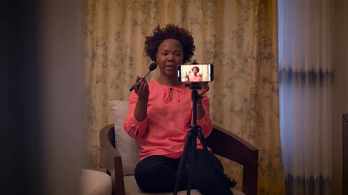 Woman Recording a Makeup Tutorial at Home