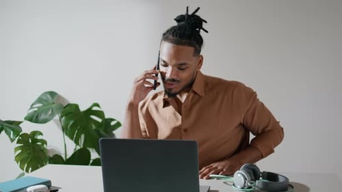 Positive Freelancer Talking Phone in Light Office Closeup. African American Man Working
