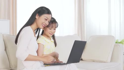 Happy Family Using Laptop Computer at Home