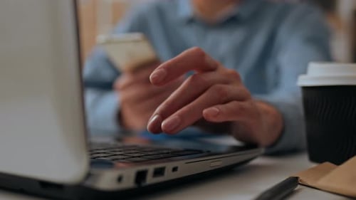 Warehouse Worker Working On Laptop Arranging Shipments For Delivery Online, Filling In The Database