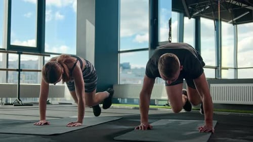 Caucasian Sportsman Man Sportswoman Woman Sporty Bodybuilders Doing Mountain Climber Exercise