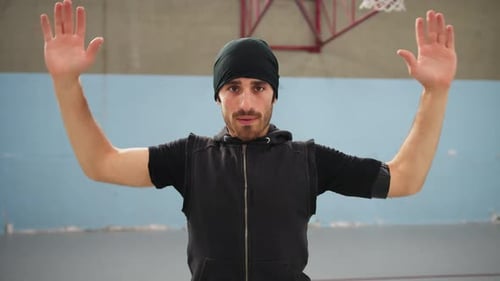 Young Man Warming Up with Arm Stretches