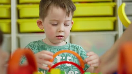 Young Boy Playing With Colorful Stacking Rings