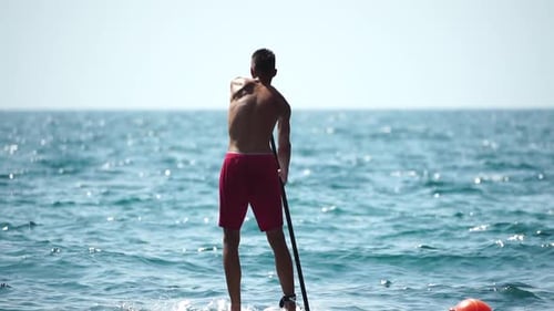 Man Sup Sea Strong Athletic Man Learns to Paddle Sup Standing on Board in Open Sea Ocean on Sunny