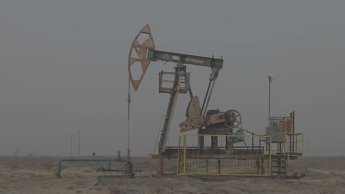Oil Industry Pumping Petroleum Rig in Desert Pump Jack Extracting Crude Oil From a Oil Well Fossil