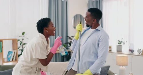 Happy Couple Cleaning and Singing Together at Home