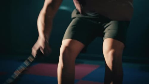 Strong Man Battling Ropes in Gym Workout