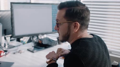 Man Working At Computer in Bright Modern Office