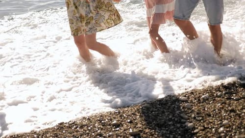Family Enjoying the Waves at the Beach
