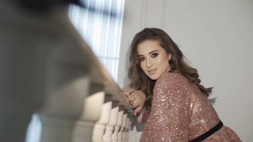 Woman in Sparkling Dress Poses Indoors