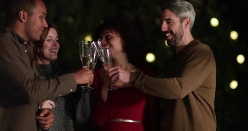 Friends Toasting Champagne at Evening Outdoor Celebration