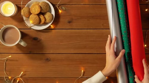 Gift Wrapping Preparation on Wooden Table with Lights