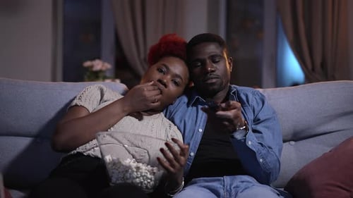 Relaxed Couple Watching Television at Home