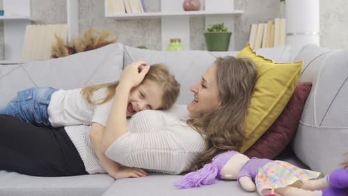 Woman and Child Talking on Couch Indoors