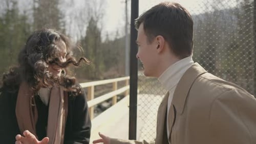 Boy and Girl Running on Bridge Over River in Mountains