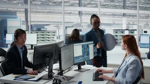 Women Working Together in Office to Examine Semiconductor Substrate