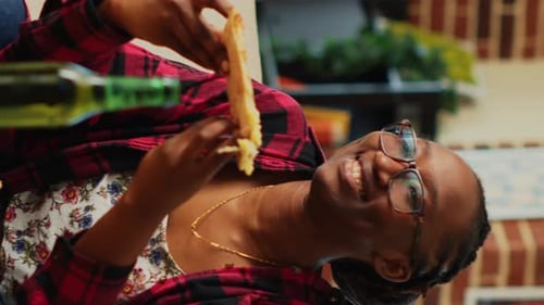 Woman Enjoys Pizza and Beer Indoors