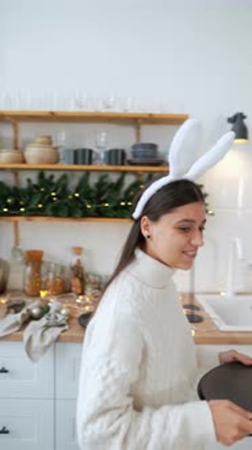 Young Woman Setting New Year's Table at Living Room