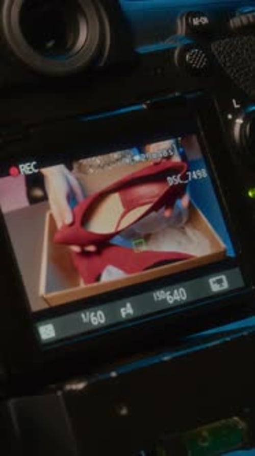 Display screen of camera showing red high heels