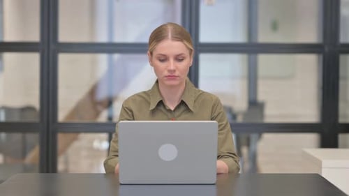 Mature Adult Woman Working on Laptop in Office