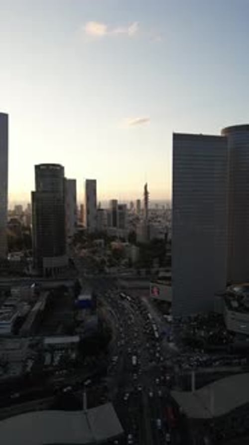 Aerial Shot Of Cityscape By Sea Against Sky At Sunset, Drone Descending Forward Over City - Tel Aviv
