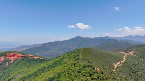 Green rocky landscape on sunny daytime. Drone footage above the picturesque mountains
