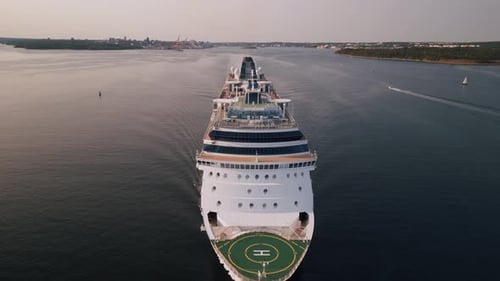 Drone Shot of a Large Cruise Ship Emerging From the Harbor Into the Open Ocean