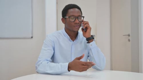 Young Adult on Phone in an Office
