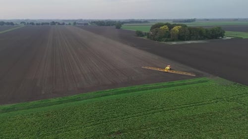 Tractor Spraying Pesticides On agricultural field With Sprayer