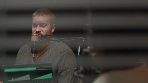 Male Radio Guest Sharing Experience while Podcasting in Studio