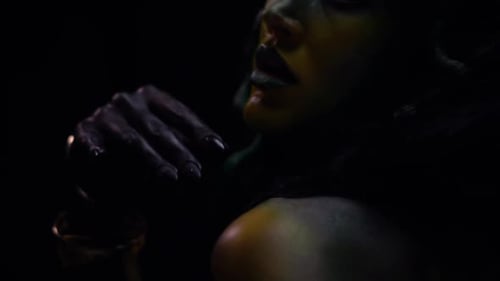 Woman with Dramatic Makeup in Dark Setting