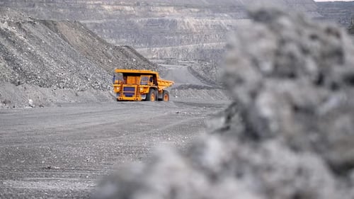 Massive Mining Truck Travels Through Open Pit Quarry