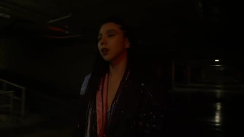 Fashionable Woman Walking in Dimly Lit Garage