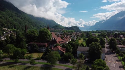 Slow ascending flight towards the chruches and township of Interlaken in the Swiss Alps. Beautiful M