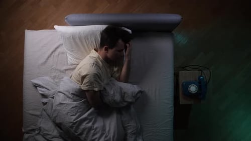 Man sleeping soundly in bed at night