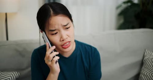 Woman Talking on Phone, Looking Stressed