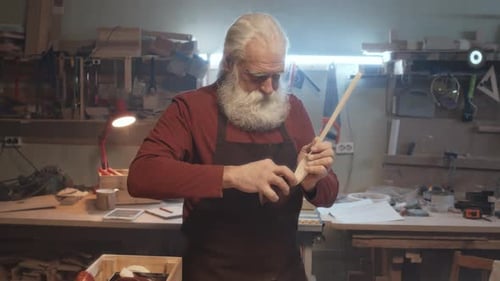 Senior Carpenter Working at His Workshop