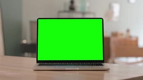Laptop with Green Screen on Desk