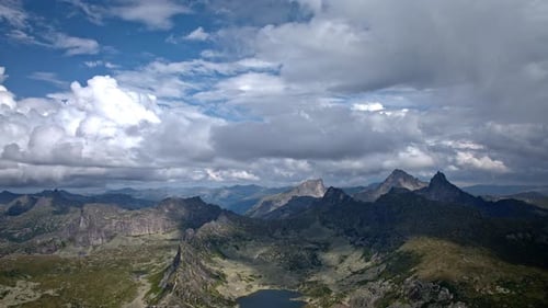 Cumulus Clouds Forming Above Mountain Lake Timelapse