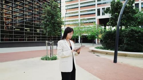 Businesswoman Using Digital Tablet Outside Office Building