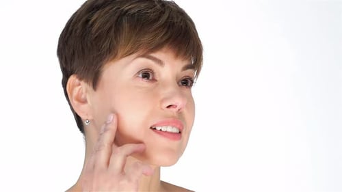 Woman Touches Her Face to Demonstrate Skincare